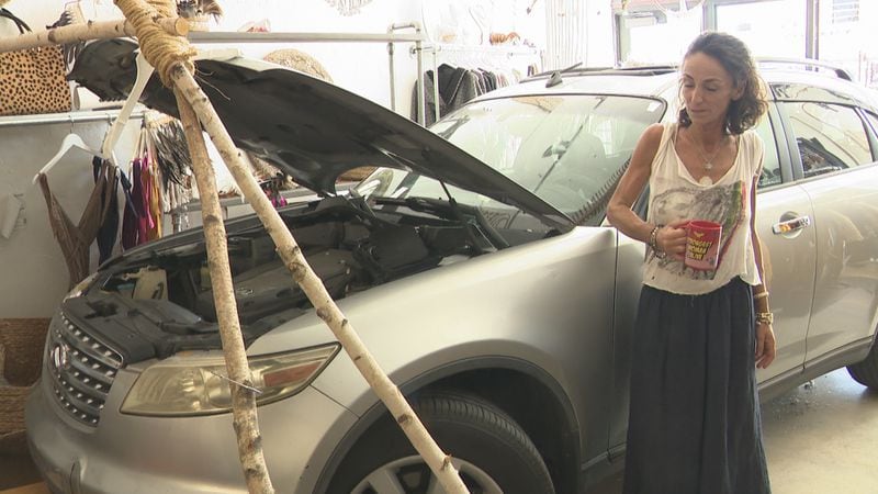 The owner of Nilaya looks on after a car crashed into her business.