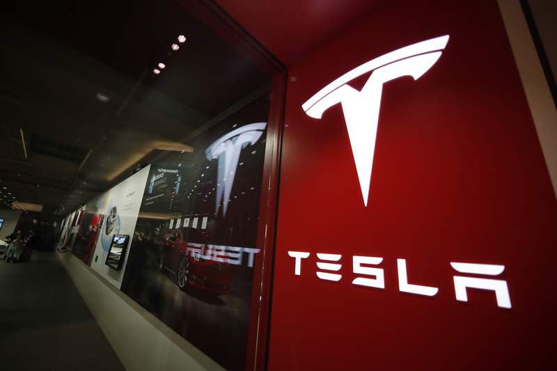 FILE - On February 9, 2019, the photo on the file shows a sign with the logo of the company outside a Tesla store in the Cherry Creek Mall in Denver.  The U.S. Government Road Safety Agency added another death, Friday, September 3, 2021, in which a Tesla was involved in the list of accidents it investigates as a result of the use of partially automated driving systems.  (AP Photo / David Zalubowski, file)