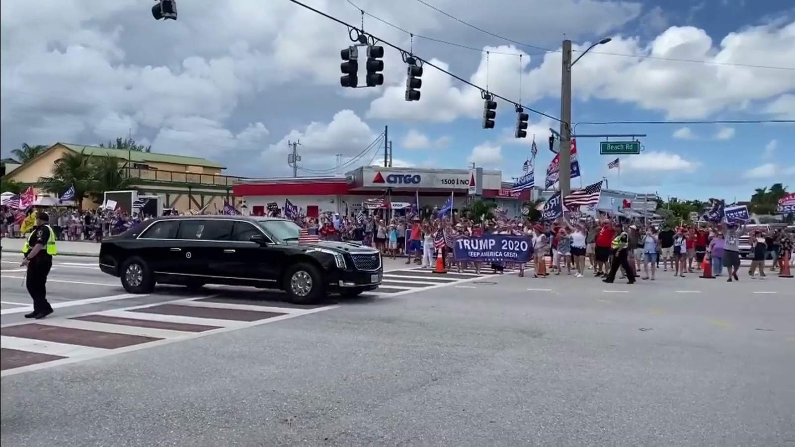 Supporters of President Trump line streets to cheer for motorcade in Jupiter