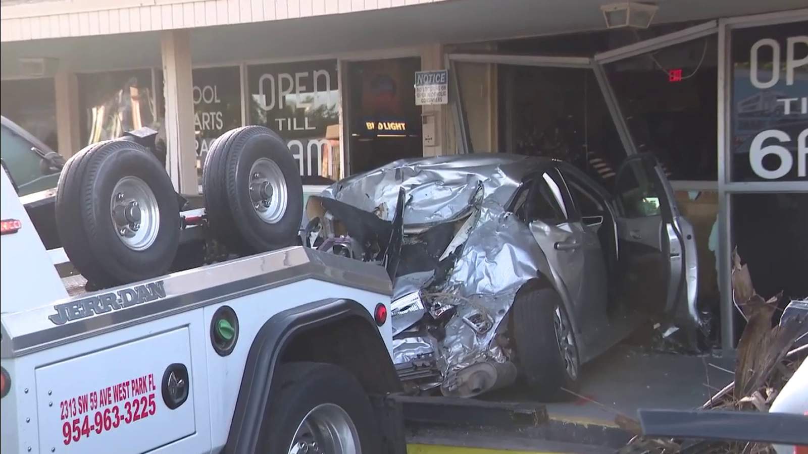 The woman dies after the car is in the air, crashes into the Pembroke Park shopping center