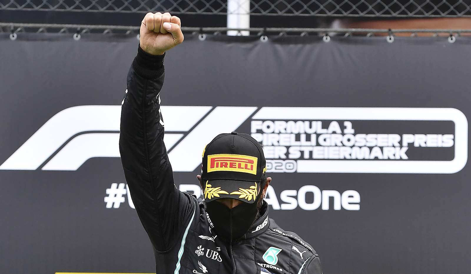 F1 star Hamilton raises right fist in fight against racism