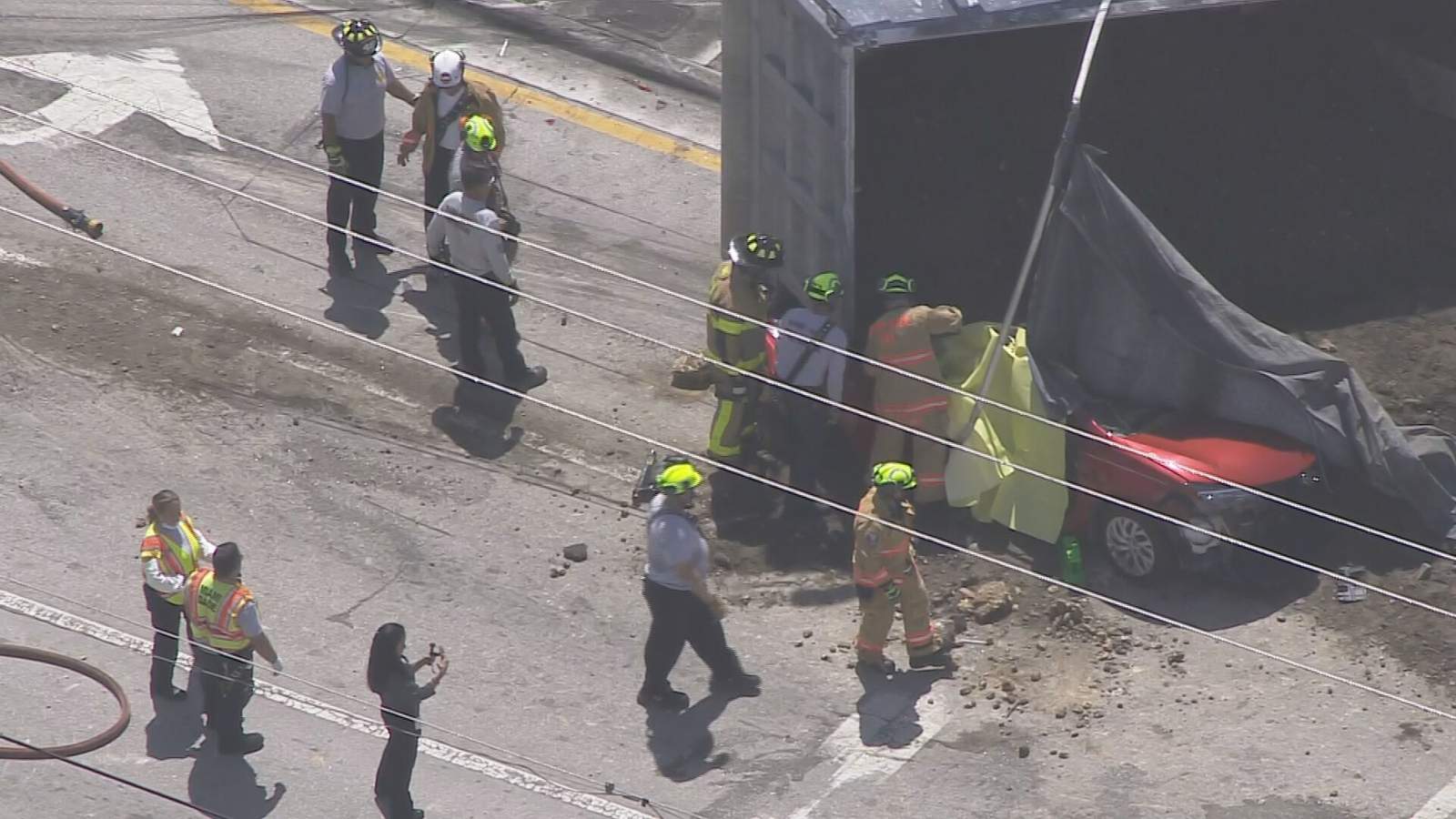 Firefighters work to free a trapped driver after a crash on Monday in Doral.