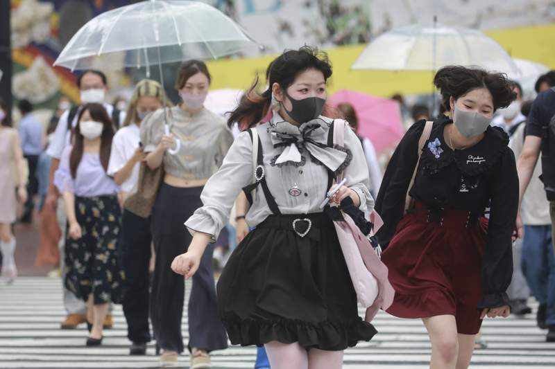 Japan expands virus emergency, weighs legal penalties