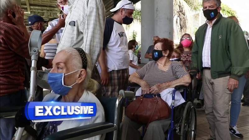Venezuelans wait in long lines in attempt to get a COVID vaccine in Caracas
