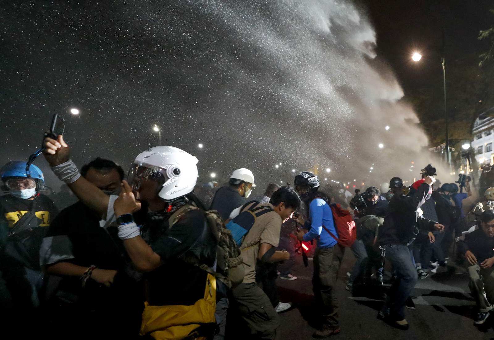 Thai protesters defy police water cannons to deliver letters