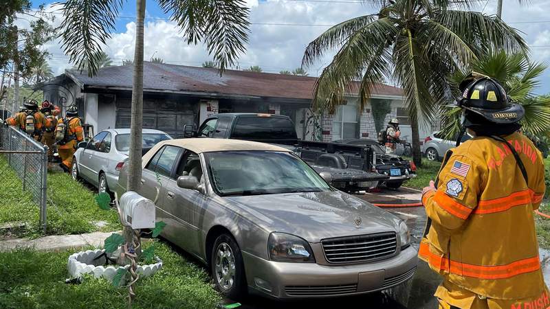 Firefighters rush to extinguish flames inside Plantation home