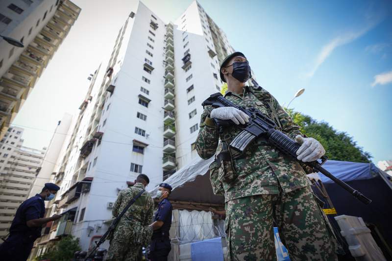 Malaysia imposes near-total lockdown after virus cases soar