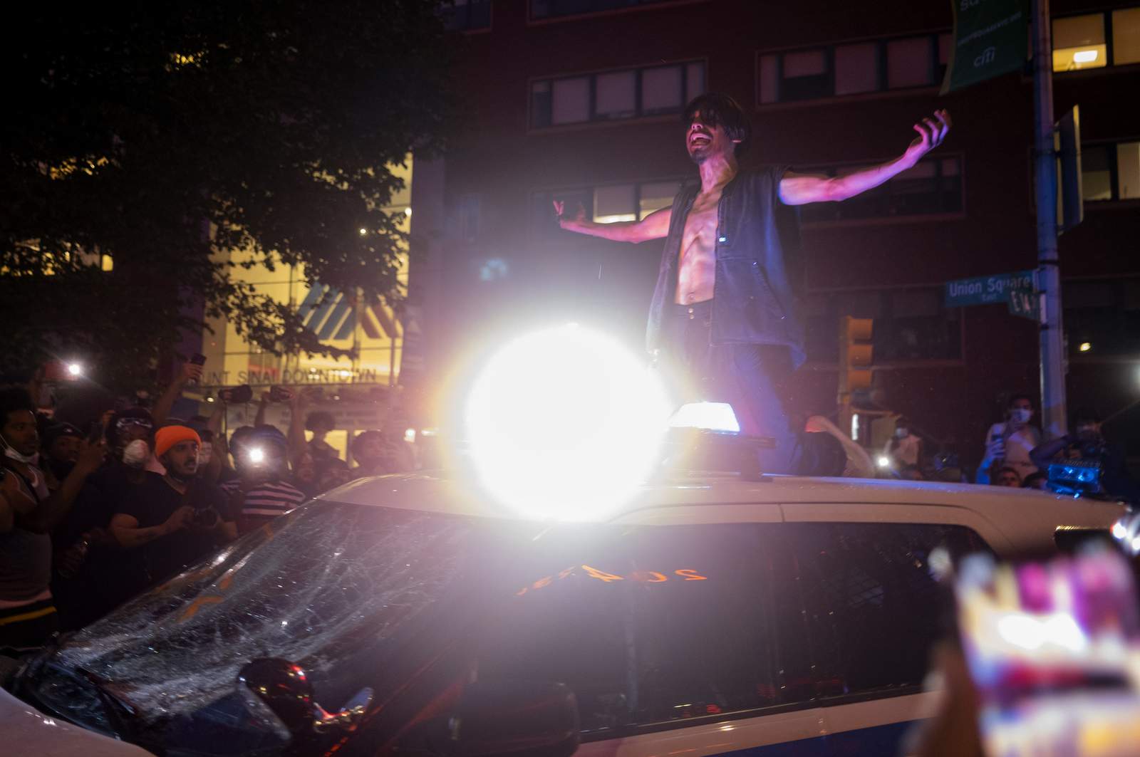 Police cars burn, windows shatter as protests roil New York