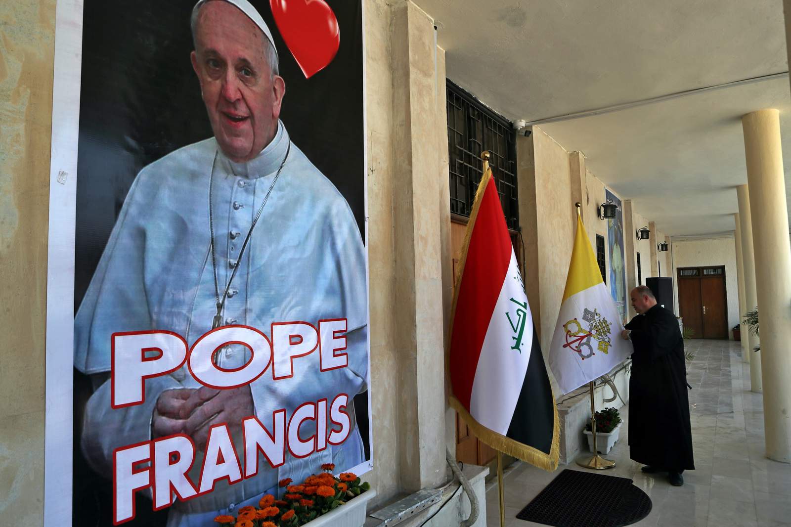 Vatican defends pope Iraq trip as virus hits as act of love