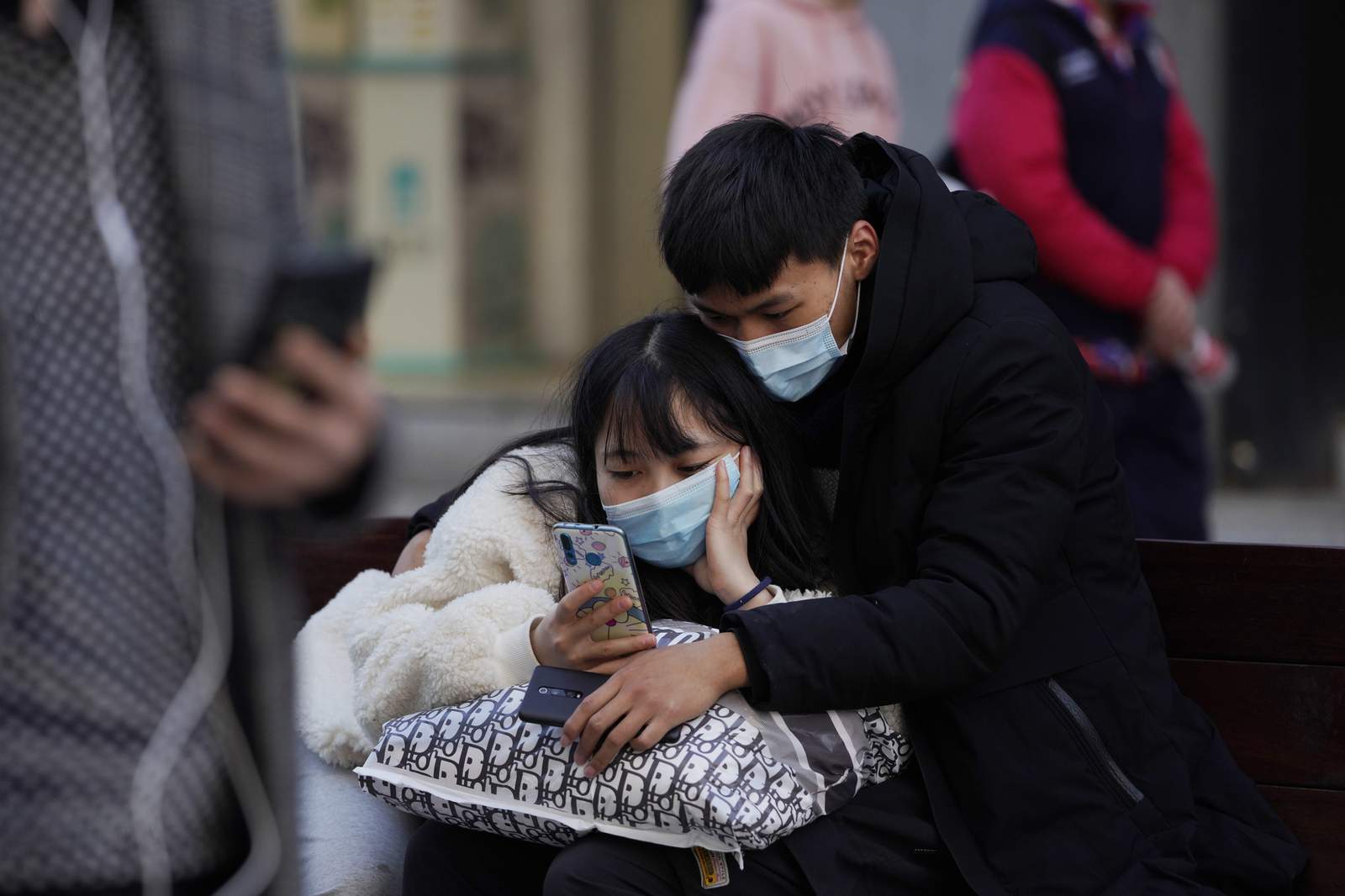 Asia Today: China virus cases spike as WHO researchers visit