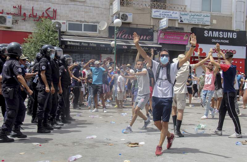 Tunisian president fires premier after violent protests