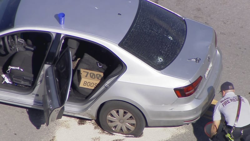 Bullet holes can be seen in the back of the windshield of this VW in Northwest Miami-Dade.