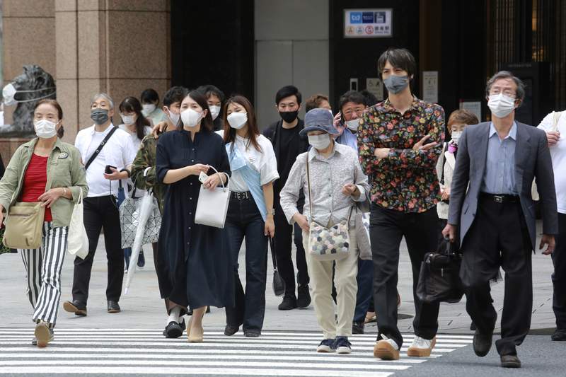 Japan extends, expands coronavirus emergency as cases surge