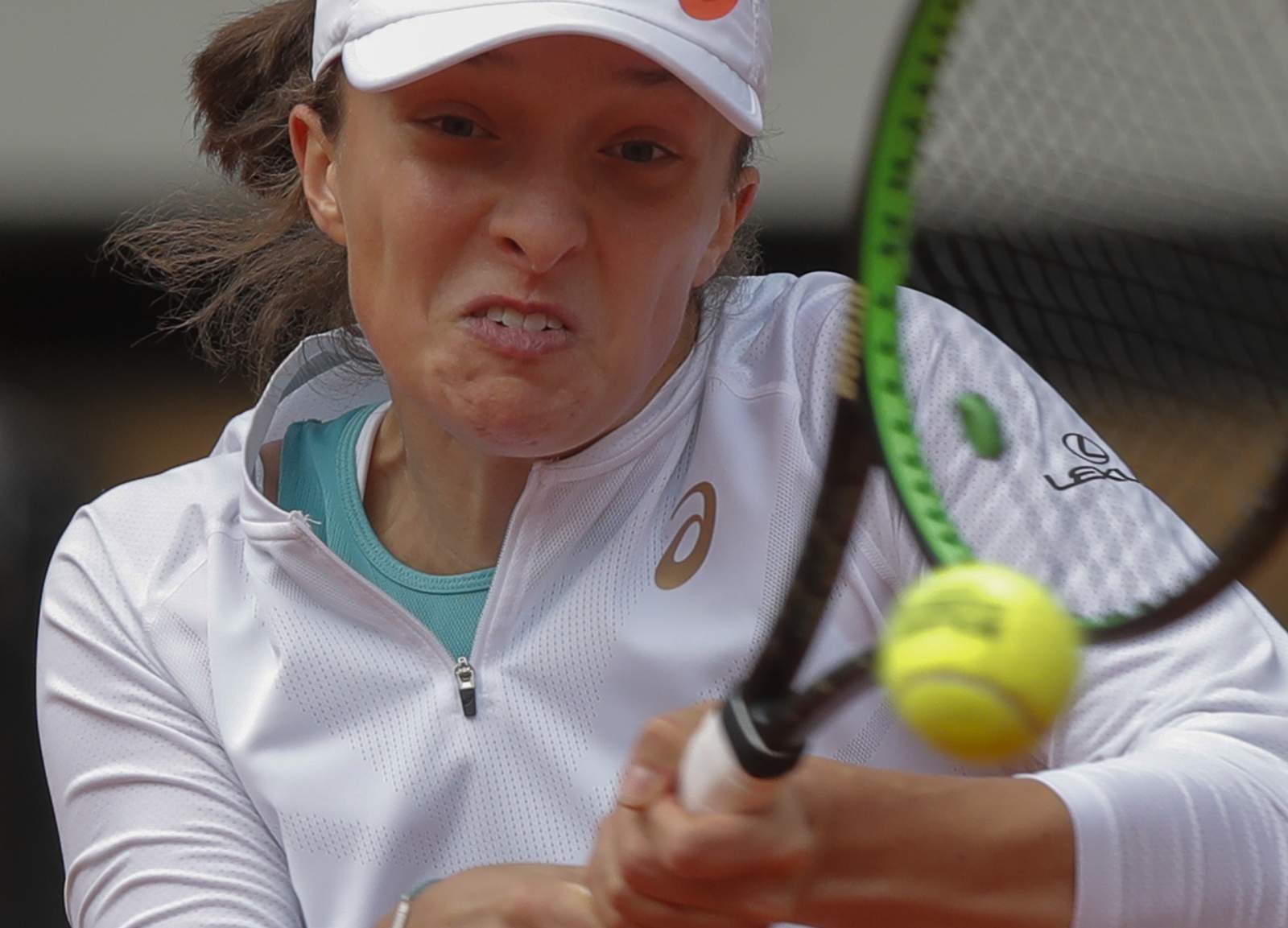 The Latest: Swiatek loses in doubles ahead of singles final