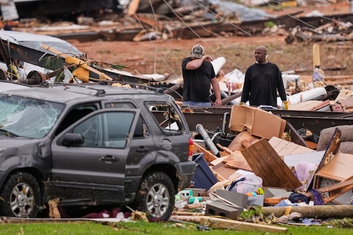Survivors of Mississippi tornadoes crawled under furniture and held onto their kids