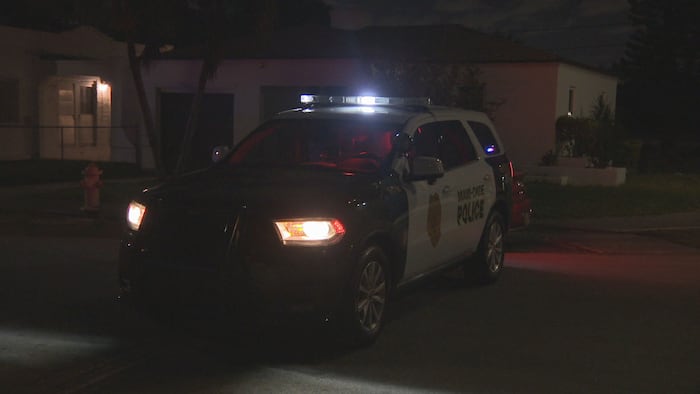 Woman shot while sitting inside car outside home in northwest Miami-Dade