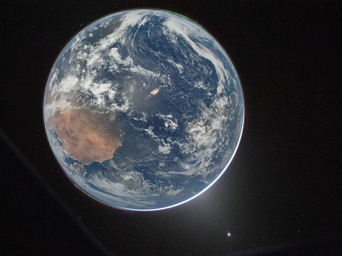 This image provided by NASA shows a view of Earth taken by NASA astronaut and Artemis II Commander Reid Wiseman from of the Orion spacecraft's window after completing the translunar injection burn on April 2, 2026. (NASA via AP)