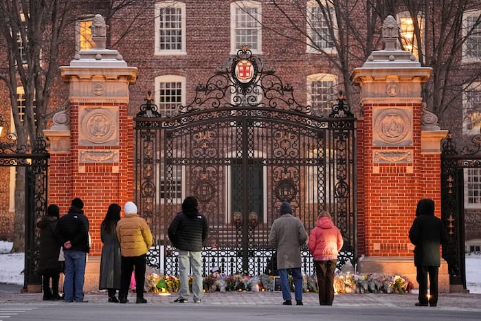Authorities knock on doors and seek evidence in the search for the Brown University shooter