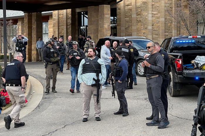 Armed man rammed vehicle into Michigan synagogue and was fatally shot by security, AP source says