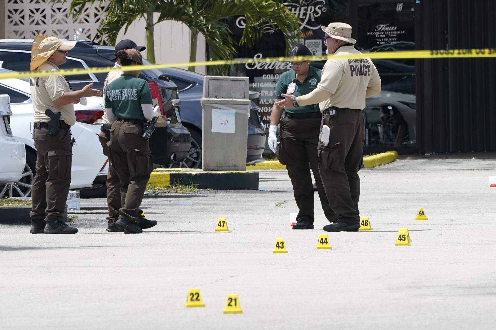 Law enforcement officials work the scene of a shooting outside a banquet hall, Sunday, in Miami-Dade County. (AP Photo/Lynne Sladky)